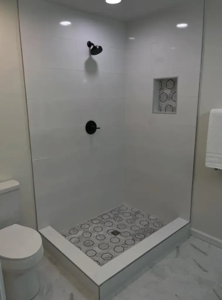 Shower floor and walls finished in small hex mosaic tile Shower floor and walls finished in small hex mosaic tile